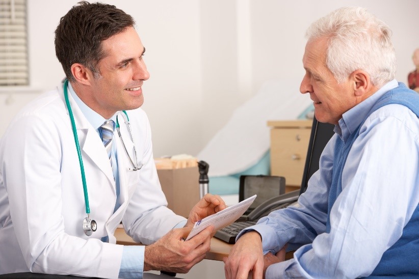 A doctor consulting with an elderly patient